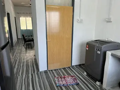 an office hallway with a door and a rug on the floor at CK Homestay Parit Buntar Perak in Bagan Serai