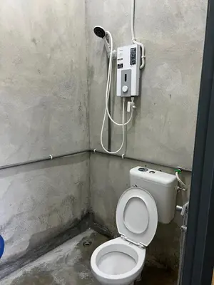 a small bathroom with a toilet in a room at CK Homestay Parit Buntar Perak in Bagan Serai