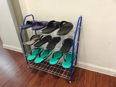 a rack with pairs of flip flops in a room at Palas Horizon Kea Farm 2-9 pax 180 View Cameron in Brinchang