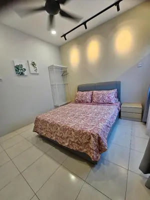 a bedroom with a bed and a ceiling fan at CozyHome - 3 bedroom Town House with unlimited free Wi-Fi in Sitiawan