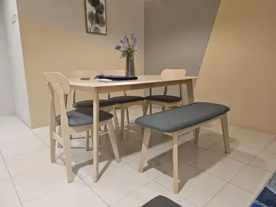 a wooden table and chairs with a vase of flowers at CozyHome - 3 bedroom Town House with unlimited free Wi-Fi in Sitiawan