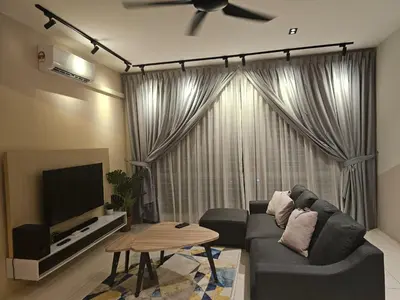 a living room with a couch and a ceiling fan at CozyHome - 3 bedroom Town House with unlimited free Wi-Fi in Sitiawan