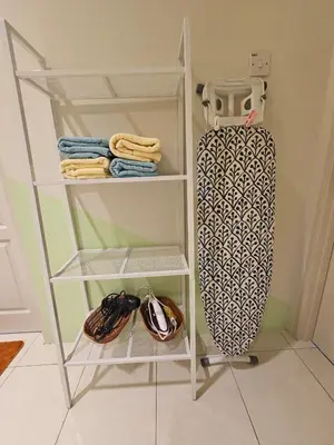 a white shelf with a skateboard in a room at CozyHome - 3 bedroom Town House with unlimited free Wi-Fi in Sitiawan