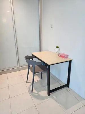a wooden table and a chair with a box on it at CozyHome - 3 bedroom Town House with unlimited free Wi-Fi in Sitiawan