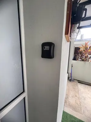 a clock on a wall next to a door at HoMestaY Kulim Seri Rambai in Kulim
