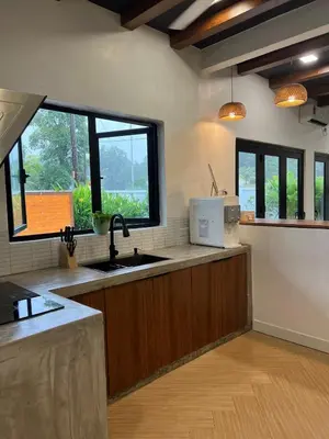 a kitchen with a sink and two windows at Dahlia Kulim Pool Homestay in Kulim