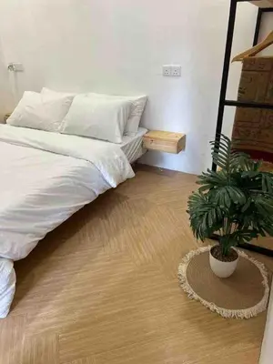 a bedroom with a bed and a potted plant at Dahlia Kulim Pool Homestay in Kulim
