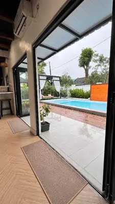a sliding glass door leading to a swimming pool at Dahlia Kulim Pool Homestay in Kulim