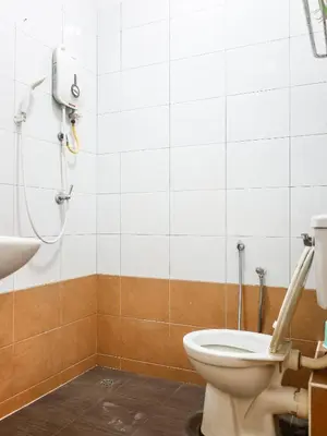 a bathroom with a toilet and a shower at Wishful Guesthouse at Georgetown#LohGuanLye#BudgetStay in George Town