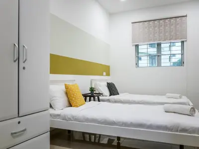 two beds in a white room with a window at Wishful Guesthouse at Georgetown#LohGuanLye#BudgetStay in George Town