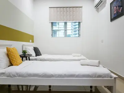 two beds in a white room with a window at Wishful Guesthouse at Georgetown#LohGuanLye#BudgetStay in George Town