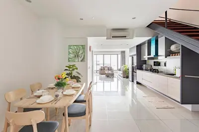 a dining room and kitchen with a table and chairs at Cozy Seaview Duplex Apartment at Sunrise Gurney in George Town