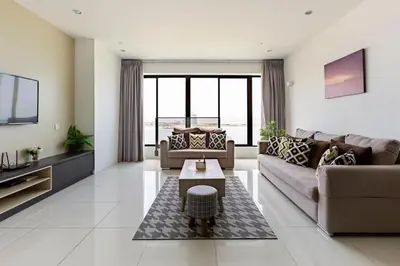 a living room with a couch and a table at Cozy Seaview Duplex Apartment at Sunrise Gurney in George Town