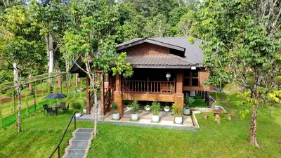 an aerial view of a house in a garden at Charming Nature Kampung Home for Family Getaways in Benta