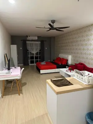 a living room with a red couch and a bed at High Floor Naz Comfort Suite Champs Elysees in Kampar