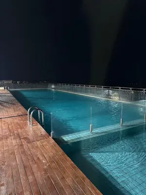 a large swimming pool with blue water at night at High Floor Naz Comfort Suite Champs Elysees in Kampar