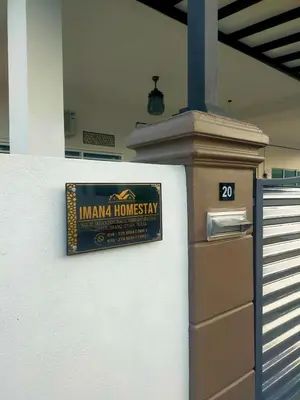 a sign on the side of a building at Iman4 Homestay in Kampung Behrang