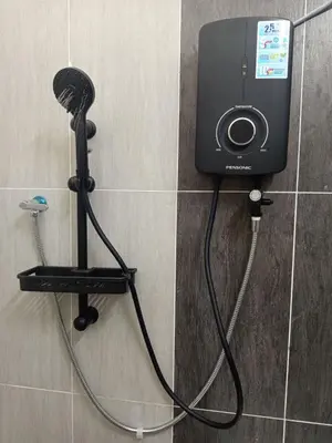 a blow dryer on a wall in a bathroom at Iman4 Homestay in Kampung Behrang