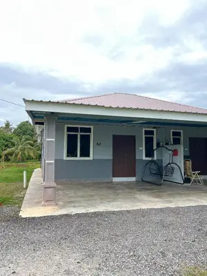 a small blue house with a pump in front of it at Nabilah Homestay Labuh Banting in Kepala Batas