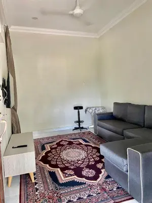 a living room with a couch and a rug at Nabilah Homestay Labuh Banting in Kepala Batas