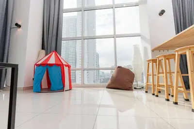 a room with a large window and a red and blue tent at Maritime Luxury Suite Seaview Sunrise in George Town