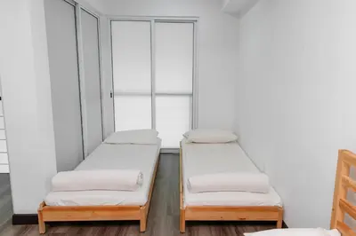 two beds in a room with two windows at Maritime Luxury Suite Seaview Sunrise in George Town