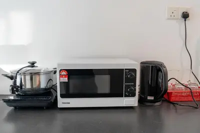 a microwave sitting on a counter next to a toaster at Maritime Luxury Suite Seaview Sunrise in George Town