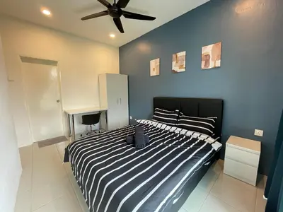 a bedroom with a black and white bed with a ceiling fan at The Anderson Residence Ipoh#1018 in Ipoh