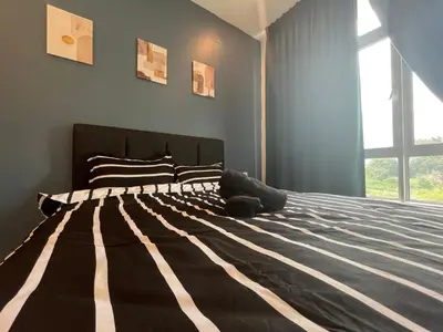 a bedroom with a large bed with a large window at The Anderson Residence Ipoh#1018 in Ipoh