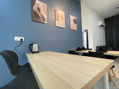 a meeting room with a wooden table and chairs at The Anderson Residence Ipoh#1018 in Ipoh