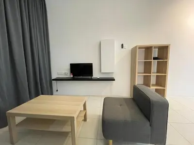 a living room with a table and a chair at The Anderson Residence Ipoh#1018 in Ipoh