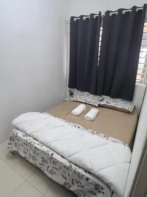a bed with two pillows on it in a bedroom at AYAAN COZY PRIMA HOMESTAY FREE WiFi in Tanah Rata
