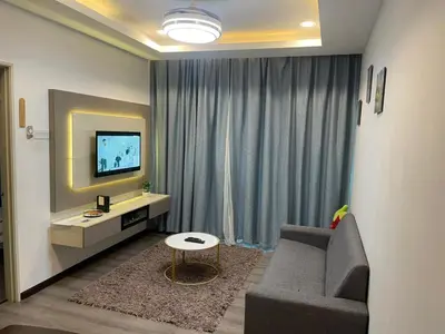 a living room with a couch and a television at AYAAN COMFY PRIMA HOMESTAY FREE WiFi in Tanah Rata