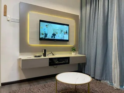 a living room with a television on a wall at AYAAN COMFY PRIMA HOMESTAY FREE WiFi in Tanah Rata