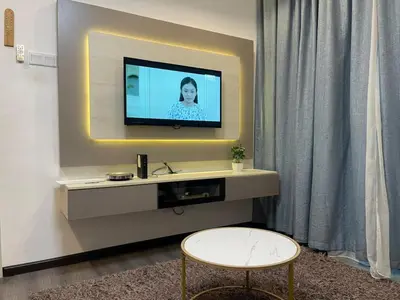 a living room with a tv on a wall at AYAAN COMFY PRIMA HOMESTAY FREE WiFi in Tanah Rata