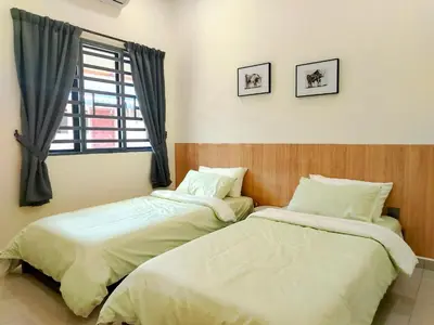two beds sitting next to each other in a bedroom at Mootopia BM homestay room rent in Bukit Mertajam