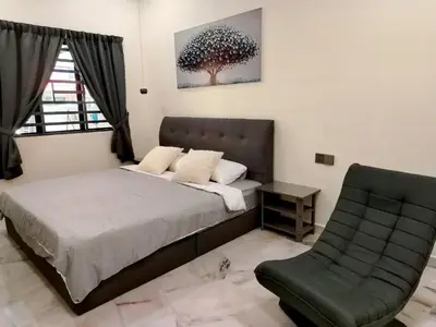 a bedroom with a bed and a chair at Mootopia BM homestay room rent in Bukit Mertajam