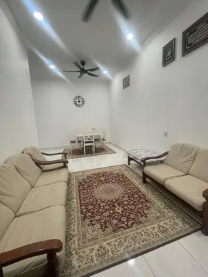 a living room with a couch and a table at Nona Homestay in Parit Buntar