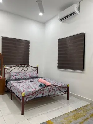 a bedroom with a bed in a room at Nona Homestay in Parit Buntar
