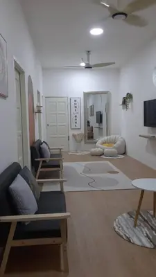 a large living room with couches and a tv at The SAFYYA House Teluk Senangin in Lumut