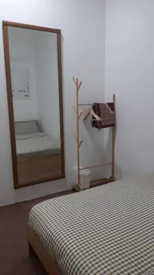 a mirror in a room with a bed and a mirror at The SAFYYA House Teluk Senangin in Lumut