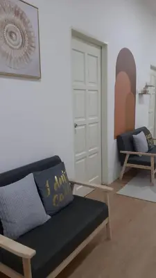 a living room with a couch and a chair at The SAFYYA House Teluk Senangin in Lumut