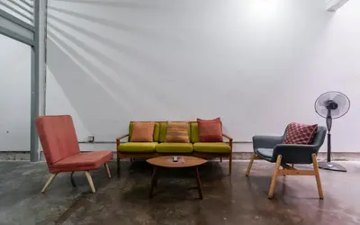 a group of chairs and a couch in a room at Aayu Heritage - Heritage Home in Stewart Lane in George Town