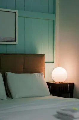 a bedroom with a bed with a lamp next to it at Aayu Heritage - Heritage Home in Stewart Lane in George Town