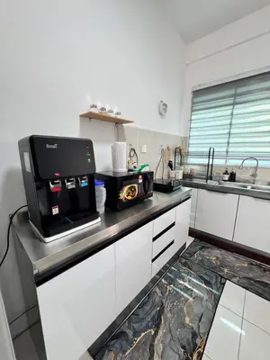a kitchen with a microwave on top of a counter at Zalins CozyHome 3BR - Double Storey Terrace in Kepala Batas