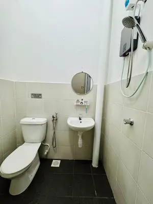 a bathroom with a toilet and a sink at Zalins CozyHome 3BR - Double Storey Terrace in Kepala Batas