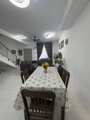 a dining room with a table with flowers on it at Zalins CozyHome 3BR - Double Storey Terrace in Kepala Batas