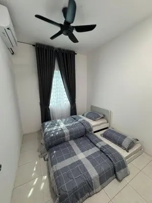two beds in a bedroom with a ceiling fan at Zalins CozyHome 3BR - Double Storey Terrace in Kepala Batas
