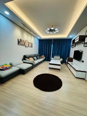a large living room with couches and a television at AYAAN PLATINUM Foosball Home at Quintet Apartment Free Parking in Tanah Rata