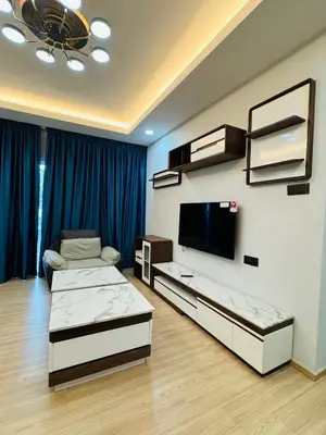 a living room with two beds and a flat screen tv at AYAAN PLATINUM Foosball Home at Quintet Apartment Free Parking in Tanah Rata